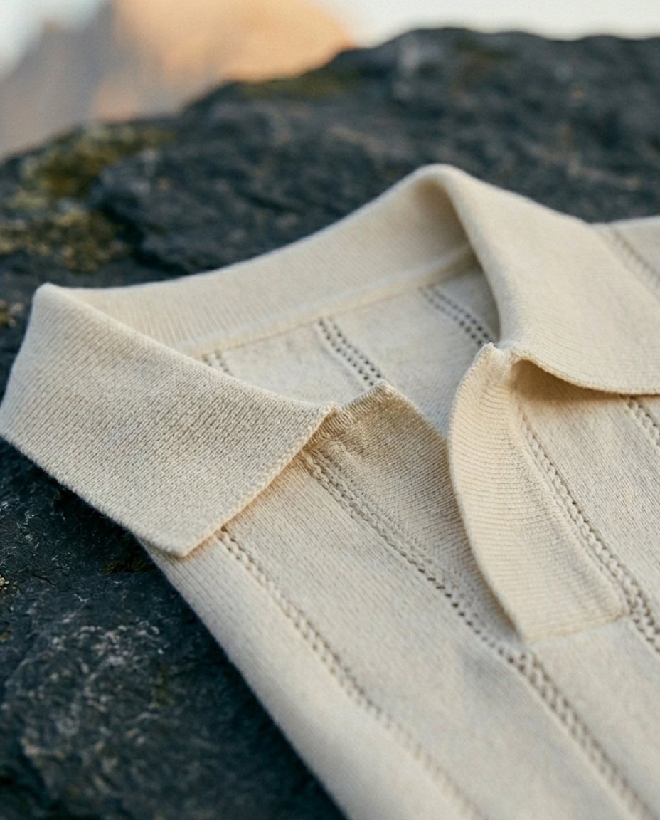 Close-up of a beige shirt collar on a textured surface
